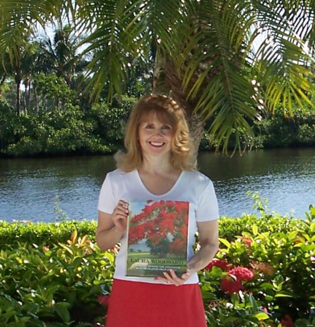 A woman with shoulder-length hair stands outdoors by a river with palm trees, holding a magazine with red flowers on the cover. She is wearing a white top and a red skirt.