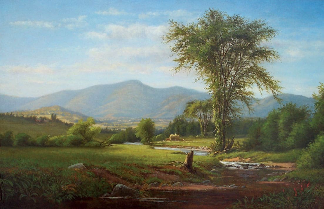 A tranquil landscape features a stream flowing through a grassy field with trees, a distant haystack, and mountains in the background under a partly cloudy sky.