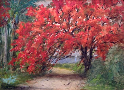 A pathway bordered by trees with vibrant red foliage, leading towards a body of water under a cloudy sky. Greenery surrounds the scene.